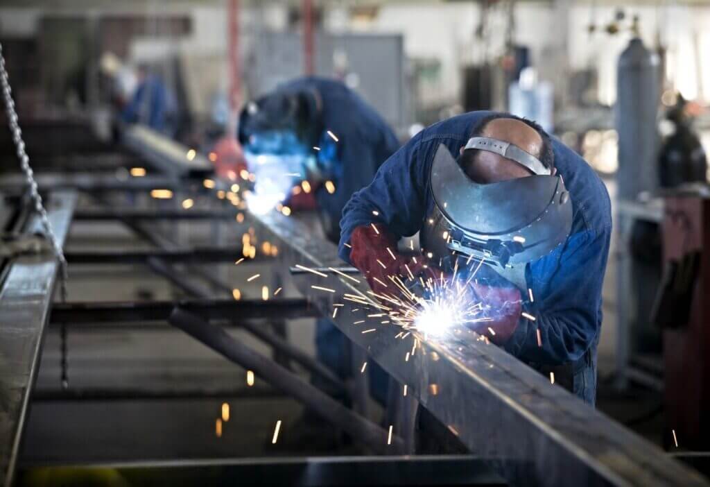 Two Persons doing metal-fabrication