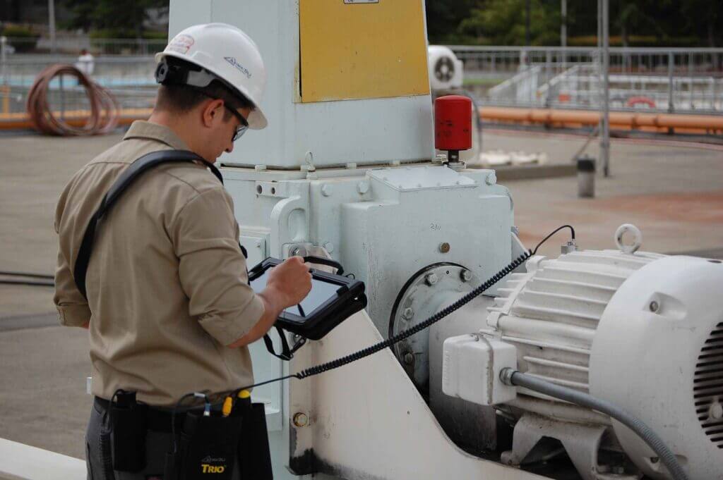 A Person Testing machinery with a device